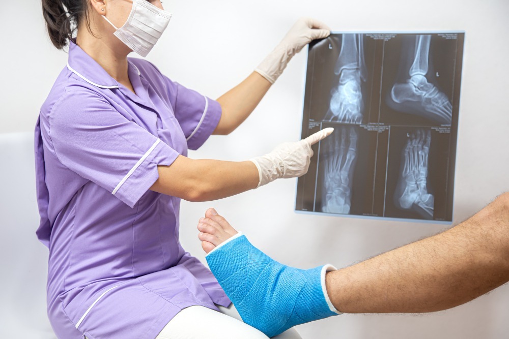 Painful Orthopedic Surgeries and the Recovery Process Orthopedic medical professional reviewing foot and ankle X-ray with a patient after painful orthopedic surgery